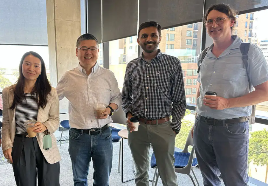 Jinjun Xiong (center) meets with faculty from the College of AI, Cyber and Computing.