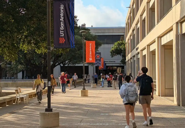 Students walk down a pathway next to the MS Building on the Main Campus