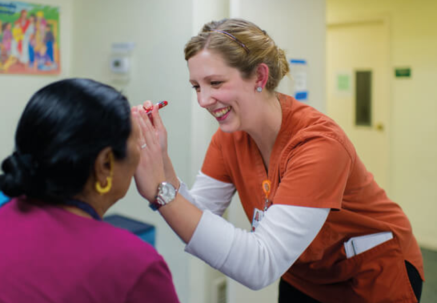 A nursing student examines a patient at the San Antonio Refugee Clinic.